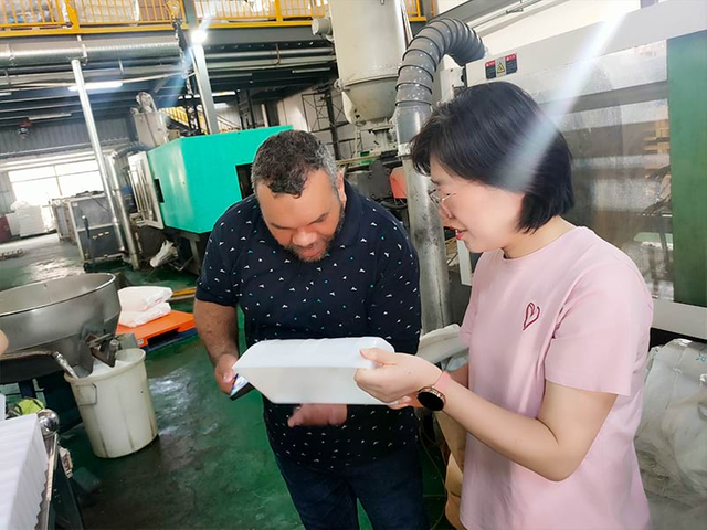 sales representative introducing conveyor solutions to visitor